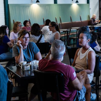 Cafe dining room full of guests.
