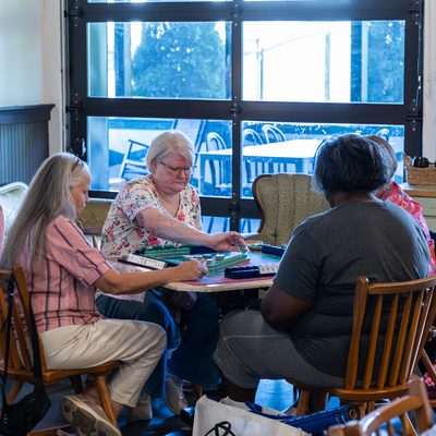 Friends playing a game at a coffee shop table.