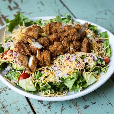 Crispy chicken salad with cheese and tomatoes.